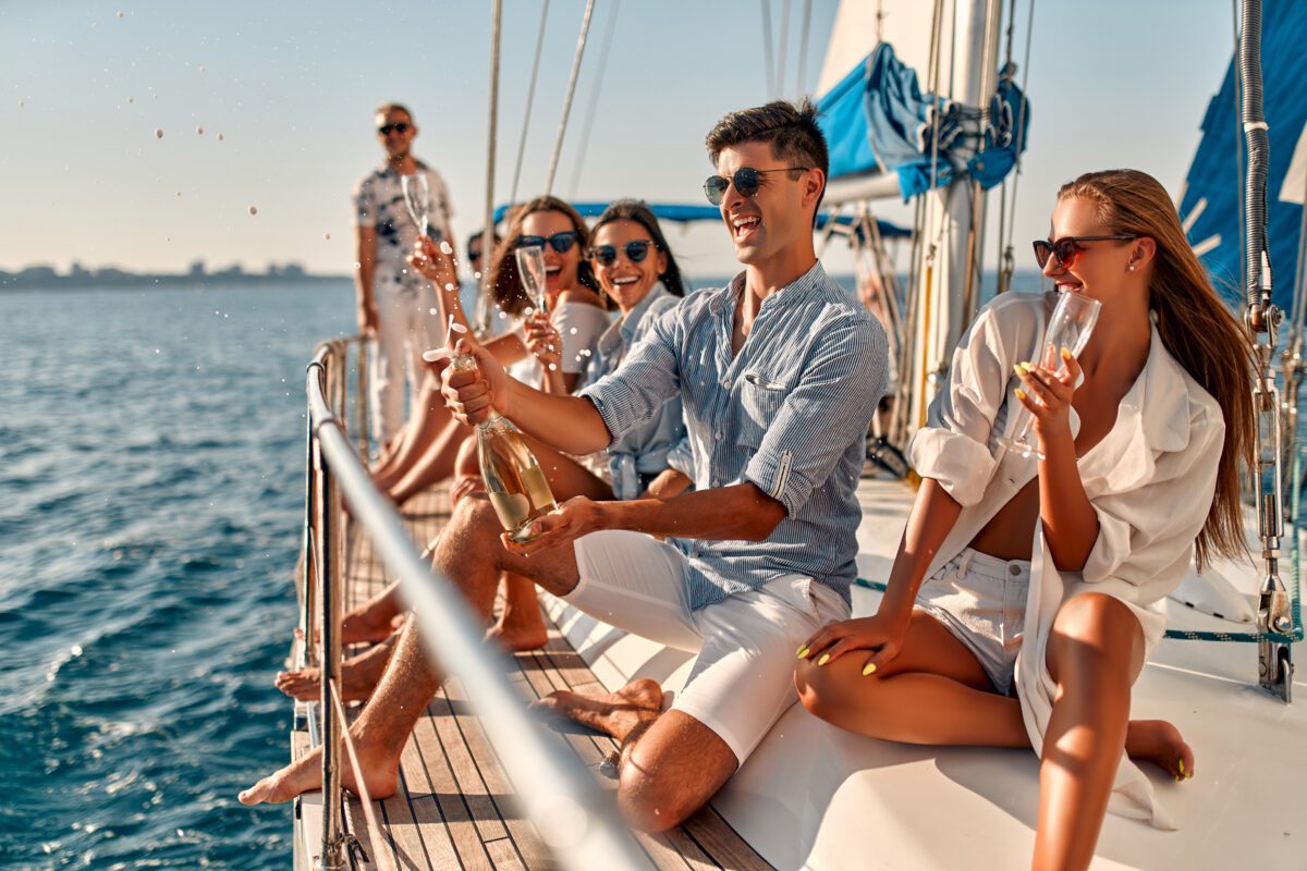 BRAIN Yachting Group of friends relaxing on luxury yacht. Having fun together while sailing in the sea. Traveling and yachting concept.